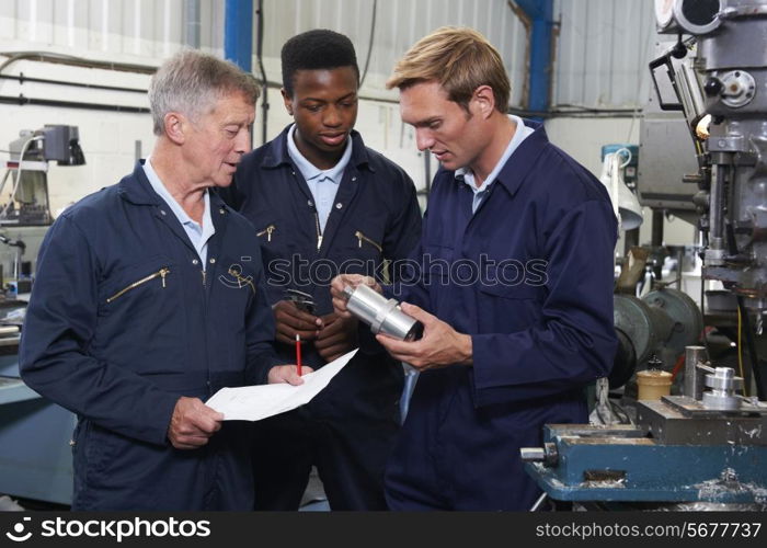 Team Of Engineers Having Discussion In Factory