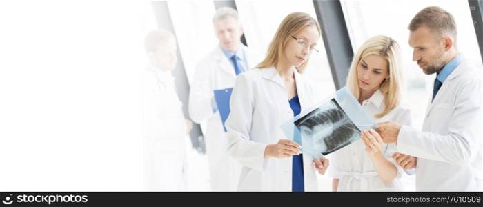Team of experts doctors looking at MRI picture at hospital office meeting. Team of expert doctors with MRI picture