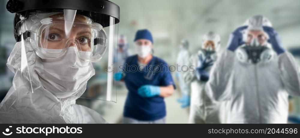 Team of Female and Male Doctors or Nurses Wearing Personal Protective Equiment In Hospital Emergency Room.
