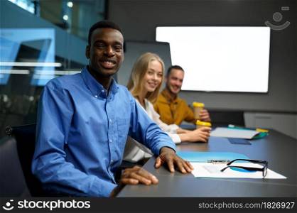 Team of happy managers, IT idea presentation in office. Professional teamwork and planning, group brainstorming and corporate work. Team of happy managers, IT idea presentation