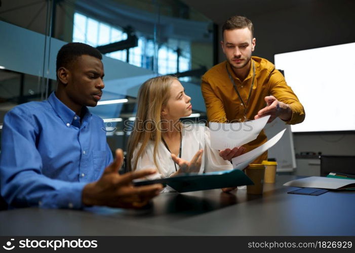 Team of managers at the table, IT idea presentation in office. Professional teamwork and planning, group brainstorming and corporate work. Managers at the table, IT idea presentation