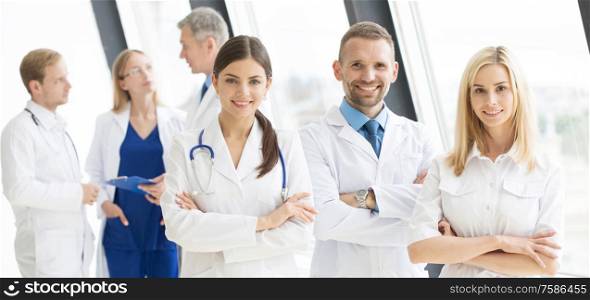 Team of medical professionals looking at camera, smiling, arms crossed. Team of medical professionals