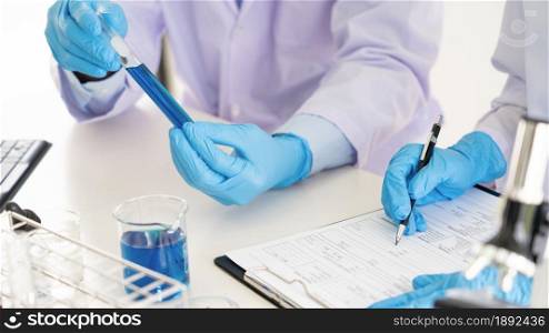 Team of Medical Research Scientists or researcher in lab coat testing their experimental in Modern laboratory