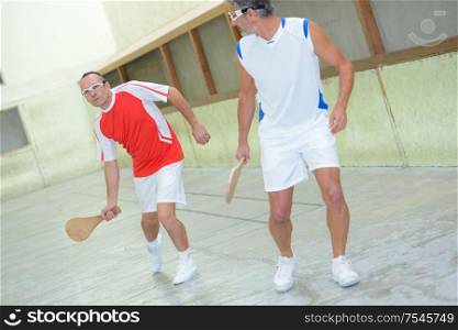 team of men playing racket sport
