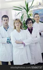 team of pharmacist chemist woman and man group standing in pharmacy drugstore