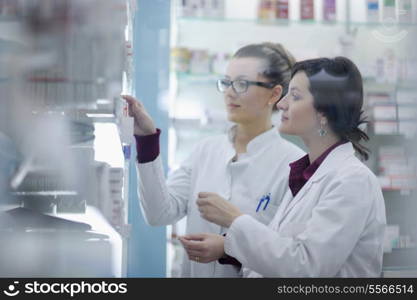 team of pharmacist chemist woman group standing in pharmacy drugstore