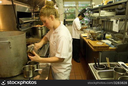 Team of restaurant kitchen staff busy at work.