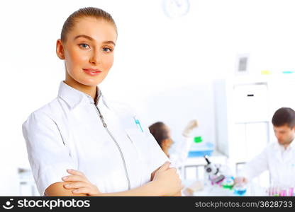 Team of scientists working with liquids in laboratory