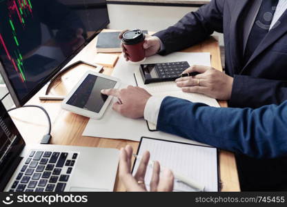 Team of stockbrokers Discussing with display screens Analyzing data, graphs and reports of stock market trading for investment