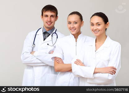 Team of three young doctors in white uniform