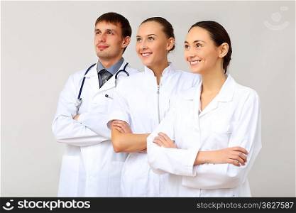 Team of three young doctors in white uniform
