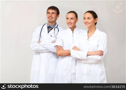Team of three young doctors in white uniform