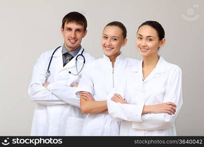 Team of three young doctors in white uniform