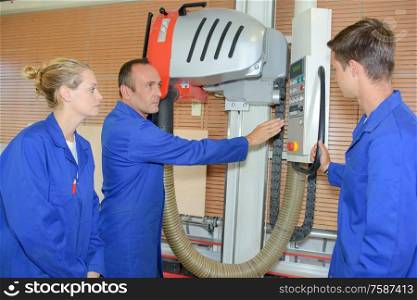 team of workers explaining complex machinery
