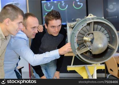 team of workers observing a propeller