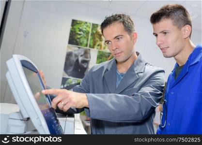 team operating a printing machine
