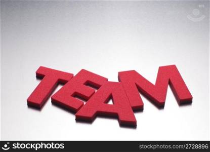 Team word on metal background, part of a series of business words
