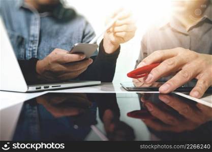 Team work concept,businessman hand attending video conference in modern office.Digital tablet laptop computer design smart phone using. Sun effects, Blurred background 