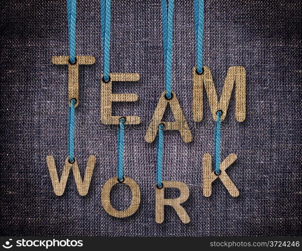 Team work Letters hanging strings with blue sackcloth background.. Team work