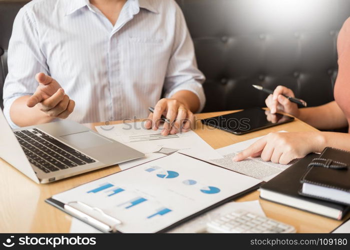 Team work process. young business managers crew working with new startup project. laptop on wood table, typing keyboard, texting message, analyze graph plans