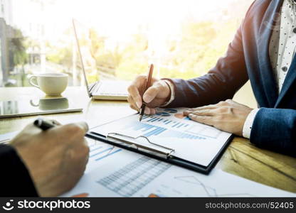 Team work process. young business managers crew working with new startup project. labtop on wood table, typing keyboard, texting message, analyse graph plans.