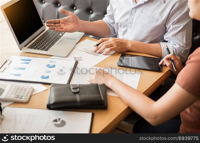 Team work process. young business managers crew working with new startup project. laptop on wood table, typing keyboard, texting message, analyze graph plans