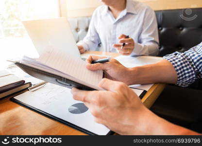 Team work process. young business managers crew working with new startup project. laptop on wood table, typing keyboard, texting message, analyze graph plans