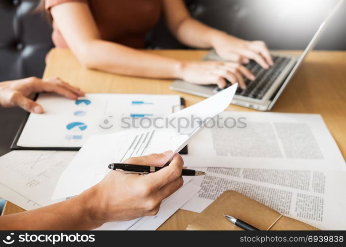 Team work process. young business managers crew working with new startup project. laptop on wood table, typing keyboard, texting message, analyze graph plans