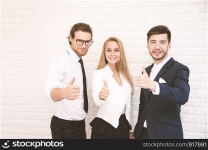 Team workers thumbs up for success in business in front of wall at cafe, Business and success concept, Teammate and Cooperation, Soft tone pinterest and instragram like process.