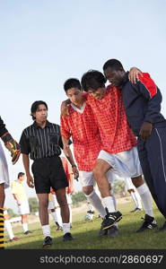 Teammates Carrying an Injured Soccer Player