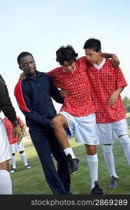 Teammates Carrying an Injured Soccer Player