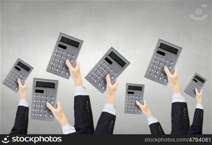 Teamwork and collaboration concept. Many hands of business people holding calculators