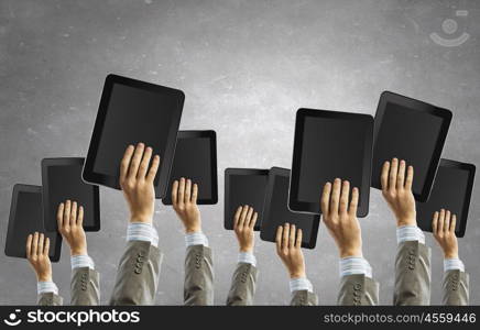 Teamwork and collaboration concept. Team of business people holding tablets in hands