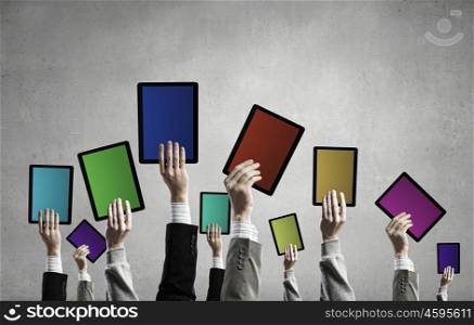 Teamwork and collaboration concept. Team of business people holding tablets in hands