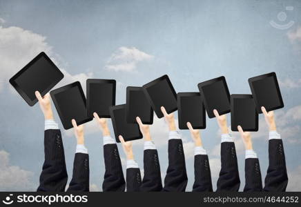 Teamwork and collaboration concept. Team of business people holding tablets in hands