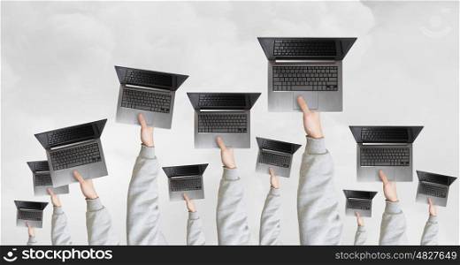Teamwork and cooperation concept. Many business people holding in hands laptops