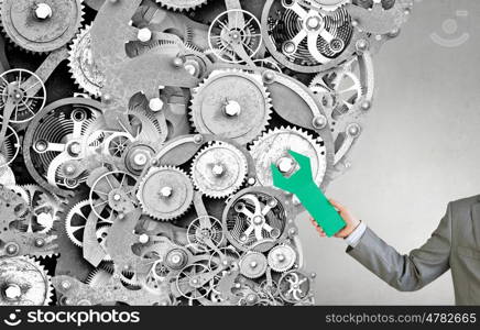 Teamwork as concept. Gears and cogwheels mechanism in hands of businessman
