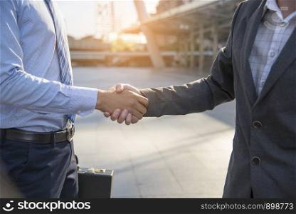 Teamwork concept. friendship business mans shaking hands together. success deal.