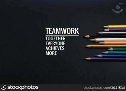 Teamwork concept. group of color pencil on black background with. Teamwork concept. group of color pencil on black background with word Teamwork, Together, Everyone, Achieves and More
