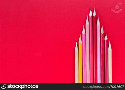 Teamwork concept. group of color pencil on red background