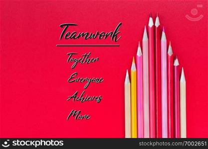 Teamwork concept. group of color pencil on red background with word Teamwork, Together, Everyone, Achieves and More
