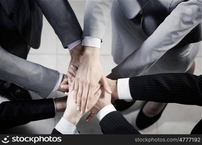 Teamwork concept. Top view of many businesspeople with hands joined in stack