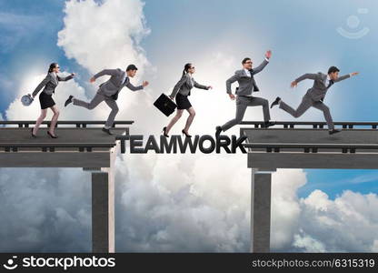 Teamwork concept with business people crossing bridge