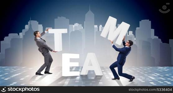 Teamwork concept with businessman putting letters