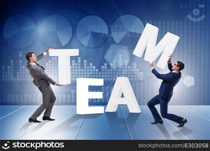 Teamwork concept with businessman putting letters