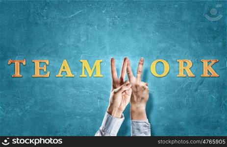 Teamwork concept. Word teamwork with fingers instead of letter W