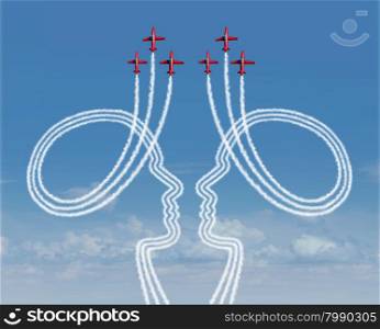 Teamwork management concept as a group of acrobatic jet airplanes creating smoke shaped as two people working together in partnership for a successful coordinated organization for success.