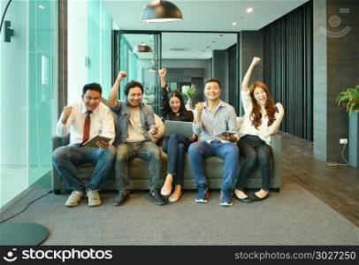 Teamwork of Asian business people sitting on sofa in lounge