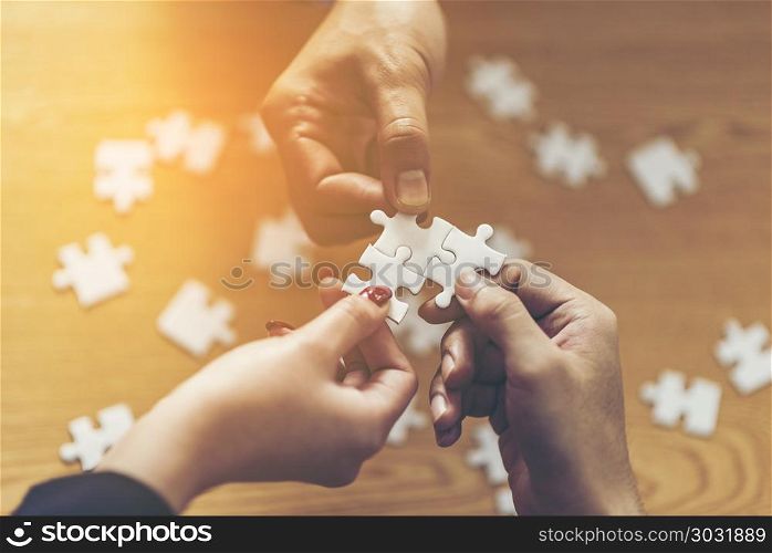 Teamwork of partners. Concept of integration and startup with puzzle pieces. double exposure
