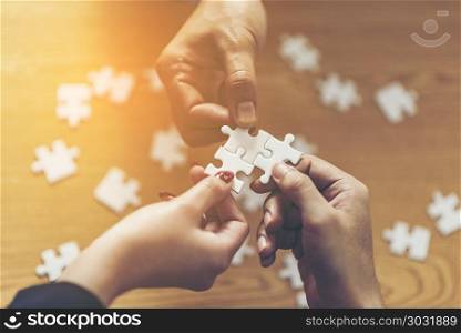 Teamwork of partners. Concept of integration and startup with puzzle pieces. double exposure